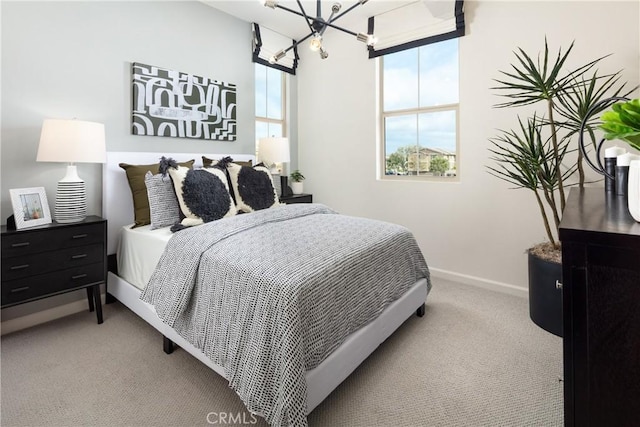 carpeted bedroom featuring a chandelier and multiple windows