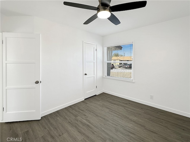 unfurnished room with ceiling fan and dark hardwood / wood-style flooring