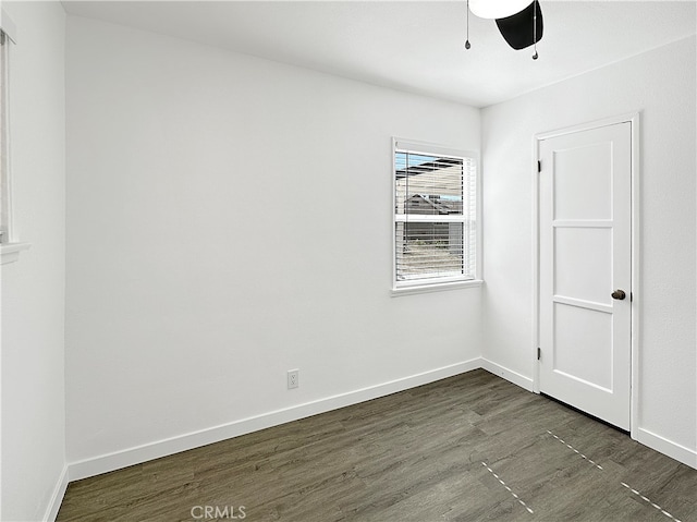 spare room featuring ceiling fan and dark hardwood / wood-style floors