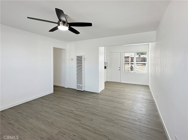 spare room featuring ceiling fan and dark hardwood / wood-style flooring