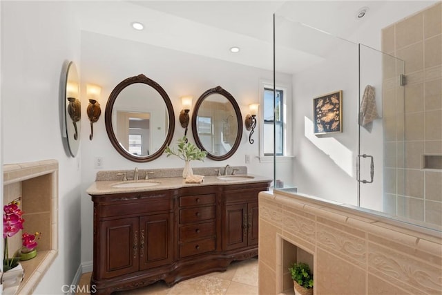 bathroom with tile patterned floors, vanity, and an enclosed shower