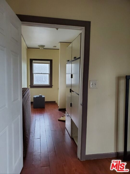 corridor featuring dark hardwood / wood-style floors