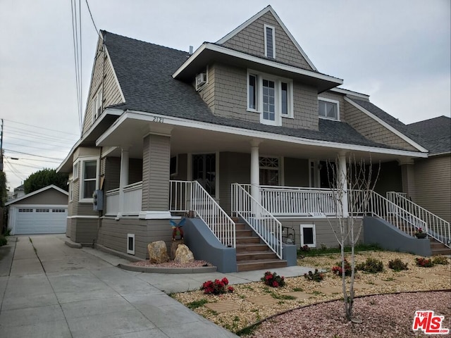 view of front of house with a porch, a garage, and an outdoor structure