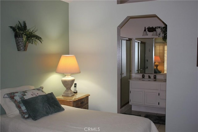 bedroom featuring light tile patterned flooring and sink