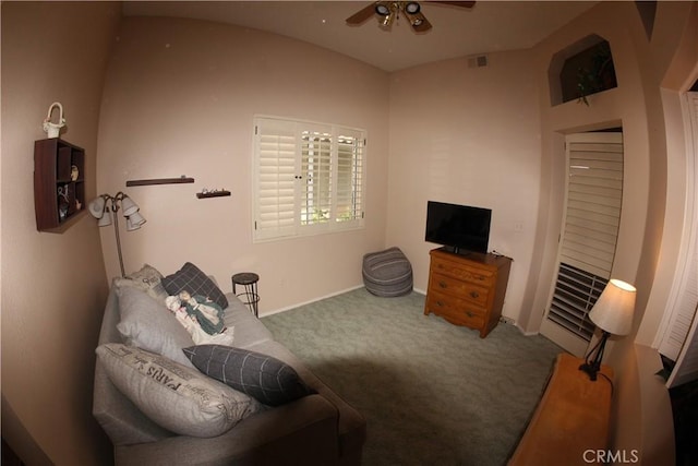 living area featuring carpet and ceiling fan