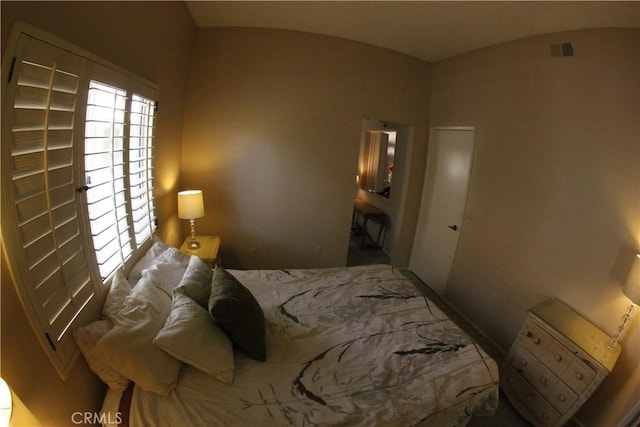 bedroom featuring vaulted ceiling