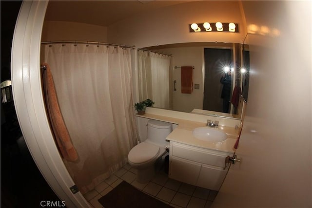 bathroom featuring tile patterned floors, vanity, and toilet