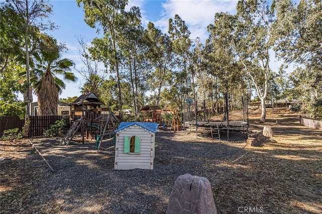 view of yard featuring a playground and a trampoline