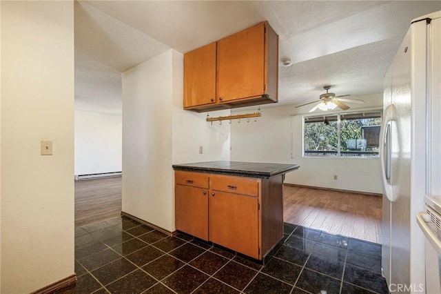 kitchen featuring kitchen peninsula, white fridge with ice dispenser, dark wood-type flooring, and a baseboard radiator