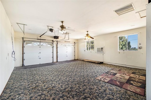 garage featuring ceiling fan, a wall unit AC, and a garage door opener