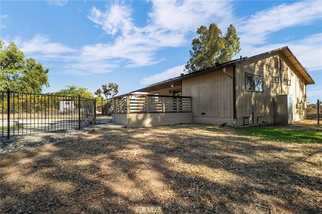 view of side of home featuring a wooden deck