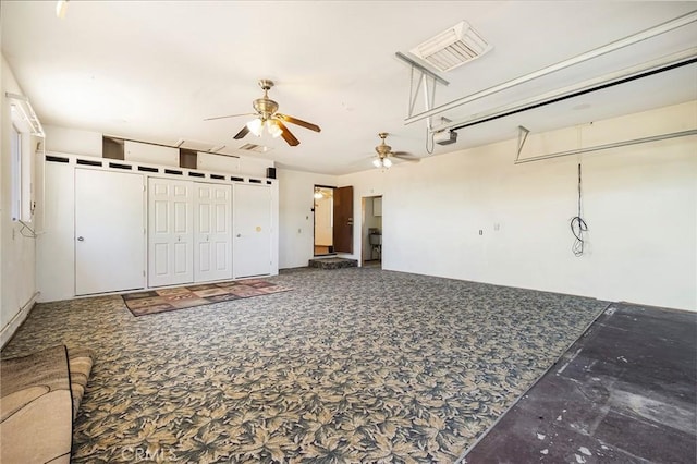 interior space with ceiling fan and a garage door opener