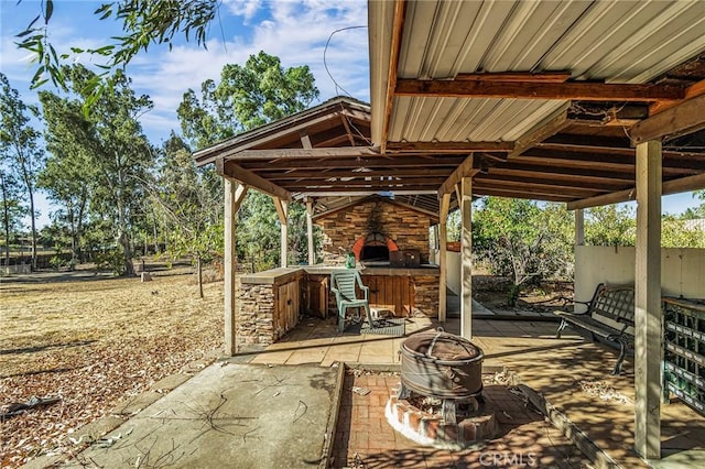 view of patio with an outdoor stone fireplace