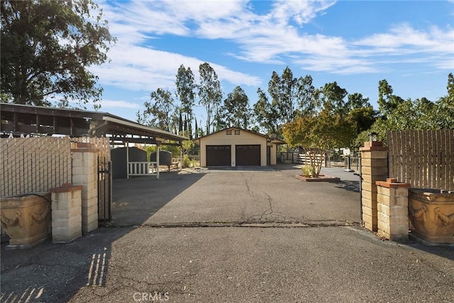 view of gate featuring an outbuilding