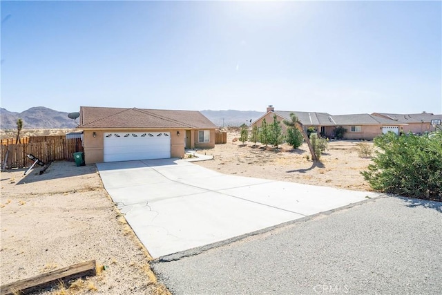 ranch-style house featuring a mountain view and a garage