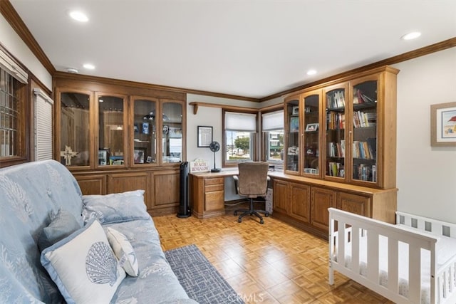 office area with built in desk and ornamental molding