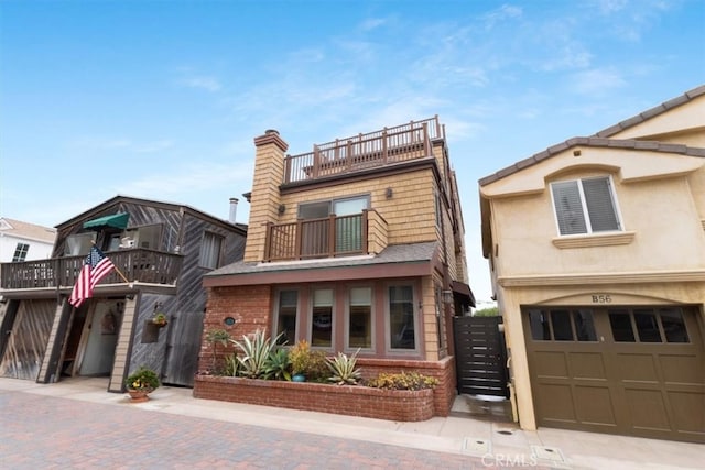 view of front of home featuring a balcony and a garage