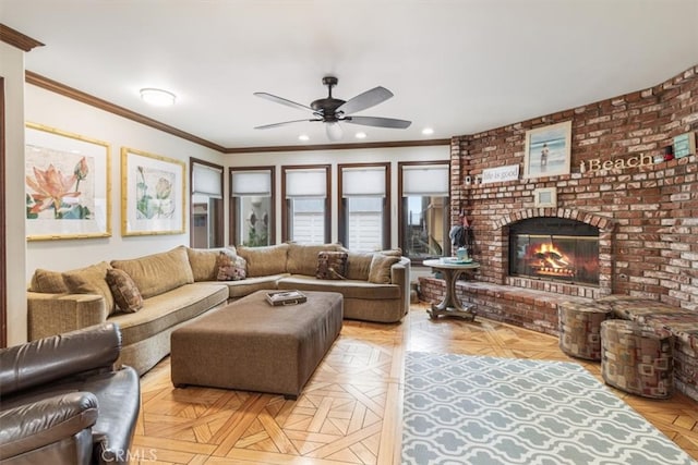 living room featuring light parquet floors, ornamental molding, a brick fireplace, and ceiling fan