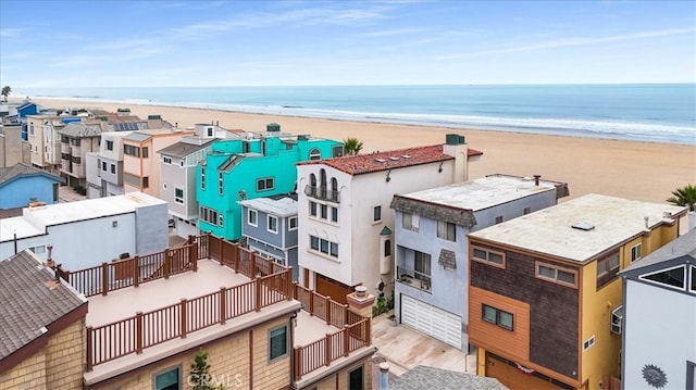 bird's eye view with a water view and a beach view