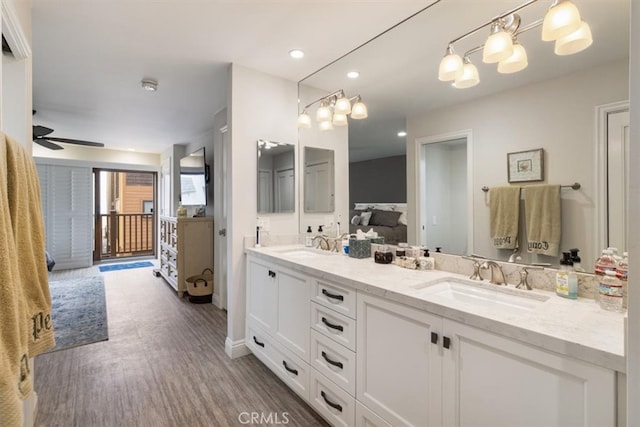 bathroom with vanity, ceiling fan, and hardwood / wood-style floors