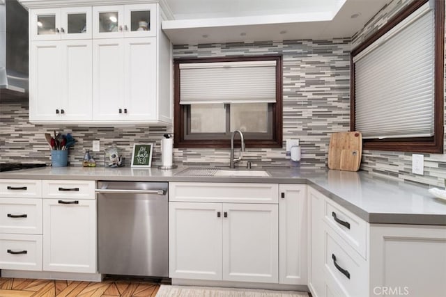 kitchen with range hood, backsplash, sink, stainless steel dishwasher, and white cabinets