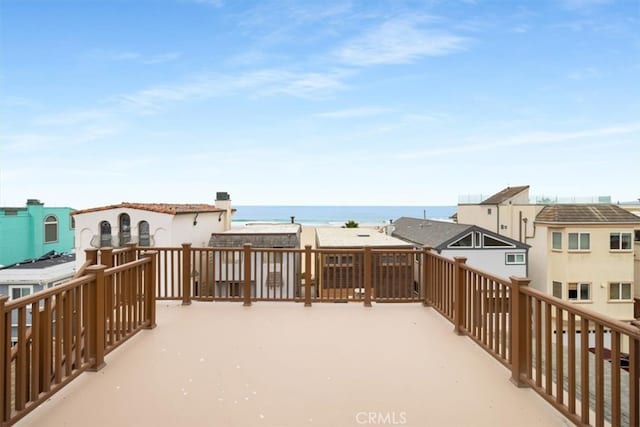 wooden terrace featuring a water view