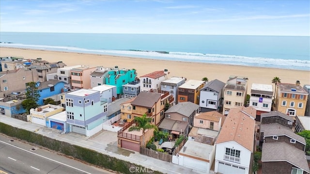 birds eye view of property with a view of the beach and a water view