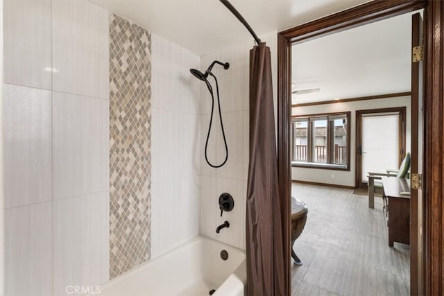 bathroom with ornamental molding and shower / tub combo