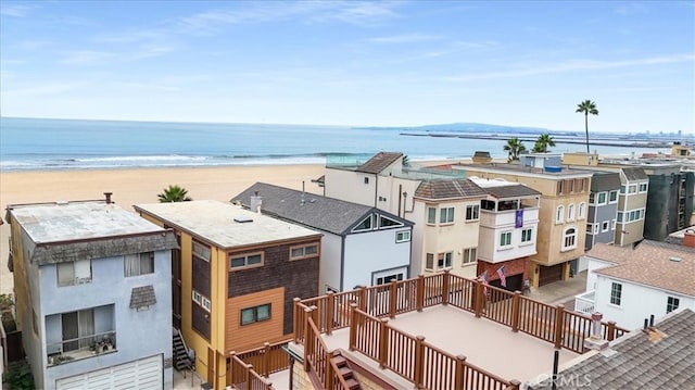 drone / aerial view with a water view and a beach view