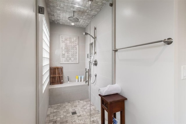 bathroom with an enclosed shower and tile patterned flooring