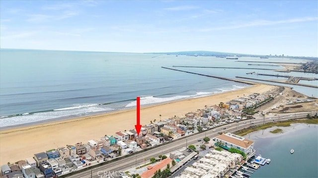 bird's eye view featuring a water view and a beach view