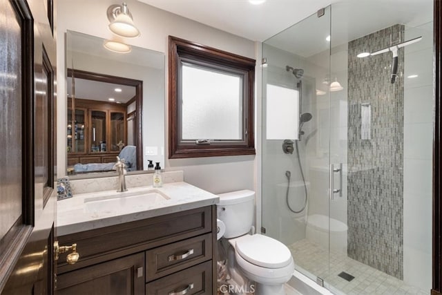 bathroom with vanity, toilet, and an enclosed shower