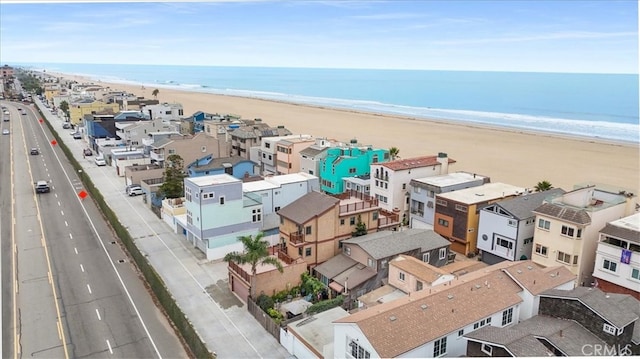 drone / aerial view featuring a water view and a beach view