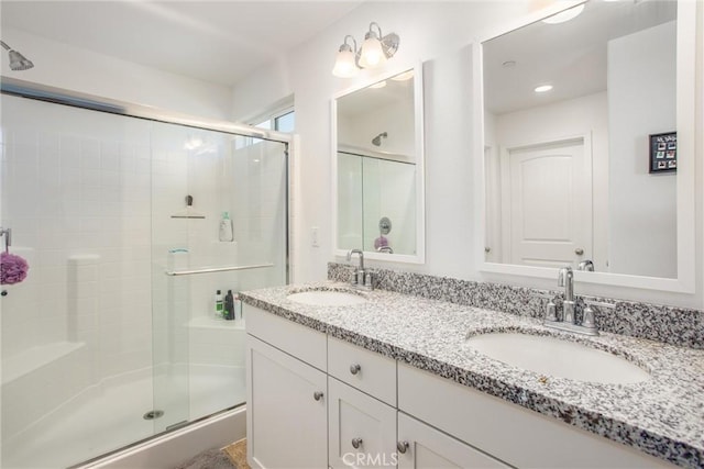 bathroom featuring vanity and a shower with shower door