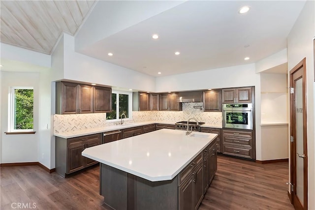 1285 N State Highway 173, Lake Arrowhead, CA 92352 - kitchen featuring appliances with stainless steel finishes, light countertops, backsplash, wall chimney range hood, and dark wood-style floors