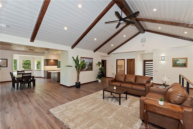 living room featuring ceiling fan, beam ceiling, wood-type flooring, and high vaulted ceiling