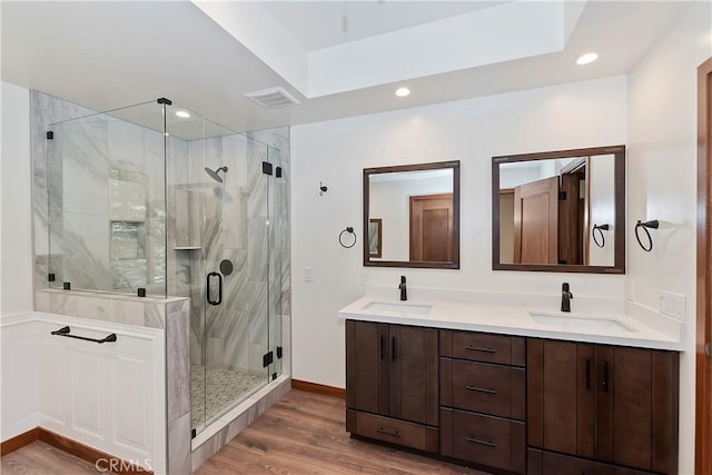 1285 N State Highway 173, Lake Arrowhead, CA 92352 - bathroom featuring double vanity, a stall shower, wood finished floors, recessed lighting, and baseboards