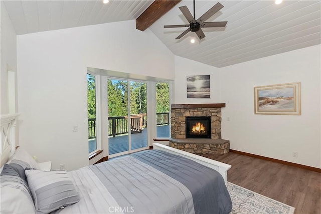 bedroom featuring access to exterior, ceiling fan, lofted ceiling with beams, a fireplace, and hardwood / wood-style flooring