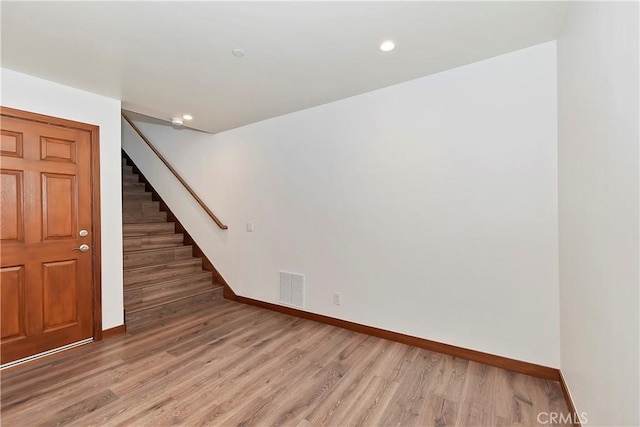 1285 N State Highway 173, Lake Arrowhead, CA 92352 - empty room featuring baseboards, stairway, light wood finished floors, and recessed lighting