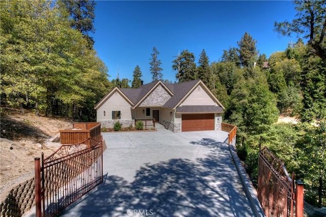 1285 N State Highway 173, Lake Arrowhead, CA 92352 - view of front facade featuring an attached garage, stone siding, and concrete driveway