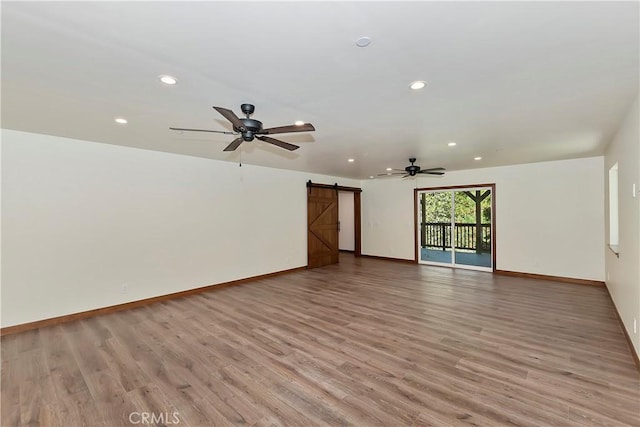 1285 N State Highway 173, Lake Arrowhead, CA 92352 - empty room featuring a barn door, ceiling fan, recessed lighting, light wood-style flooring, and baseboards