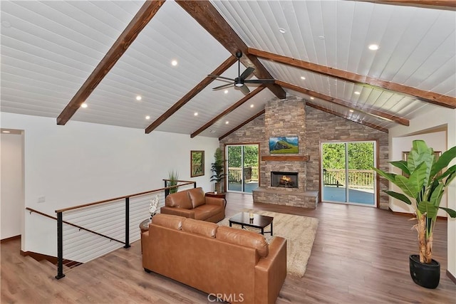 living room with a wealth of natural light, beamed ceiling, high vaulted ceiling, and wood-type flooring