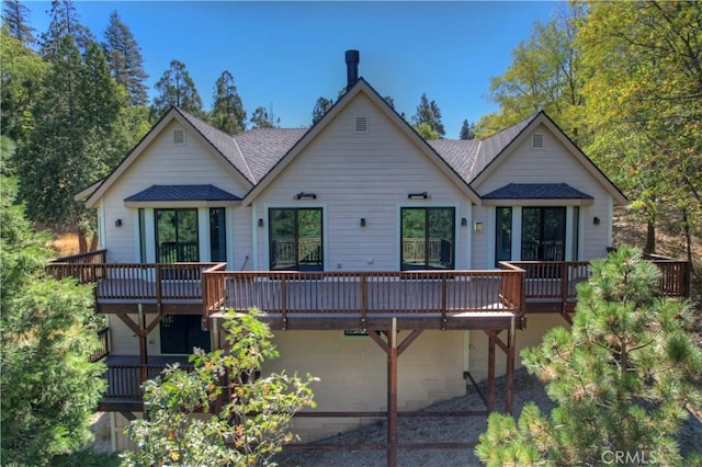 rear view of house featuring a deck