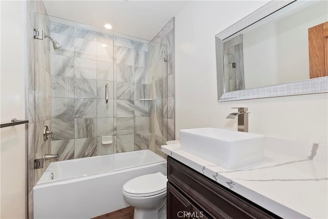 full bathroom featuring vanity, enclosed tub / shower combo, and toilet