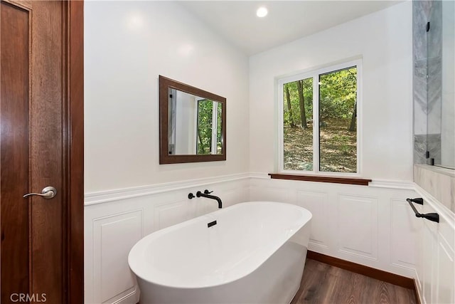 1285 N State Highway 173, Lake Arrowhead, CA 92352 - full bath featuring a soaking tub, a decorative wall, a wainscoted wall, wood finished floors, and recessed lighting