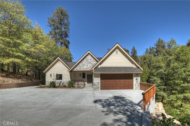 1285 N State Highway 173, Lake Arrowhead, CA 92352 - view of front of house with stone siding, driveway, and a garage