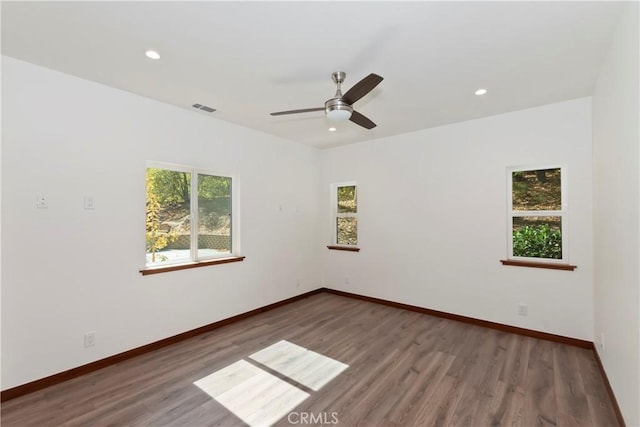 spare room with ceiling fan and dark hardwood / wood-style flooring