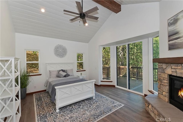 bedroom with access to exterior, ceiling fan, dark wood-type flooring, high vaulted ceiling, and a fireplace