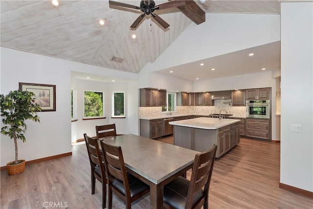 dining space featuring hardwood / wood-style floors, ceiling fan, wood ceiling, and high vaulted ceiling