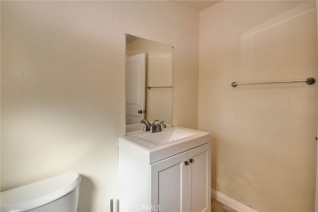 bathroom featuring toilet and vanity